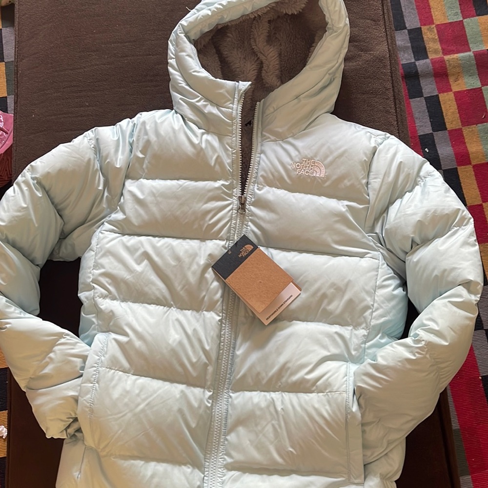 Girls large (14/16), The North Face coat.  Color described as “starlight blue.